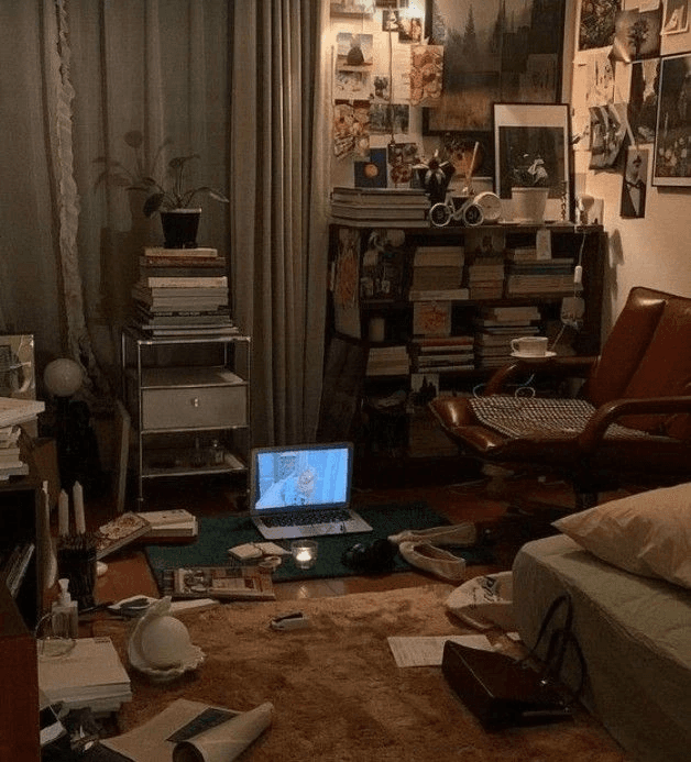 Books, papers, and a laptop spread across a room, illustrating scattered research.